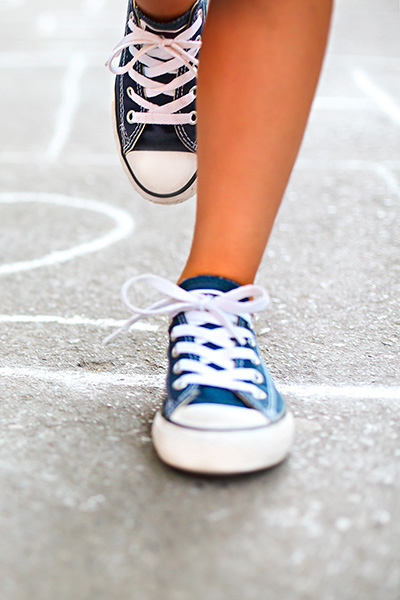 photo of a child playing hopscotch