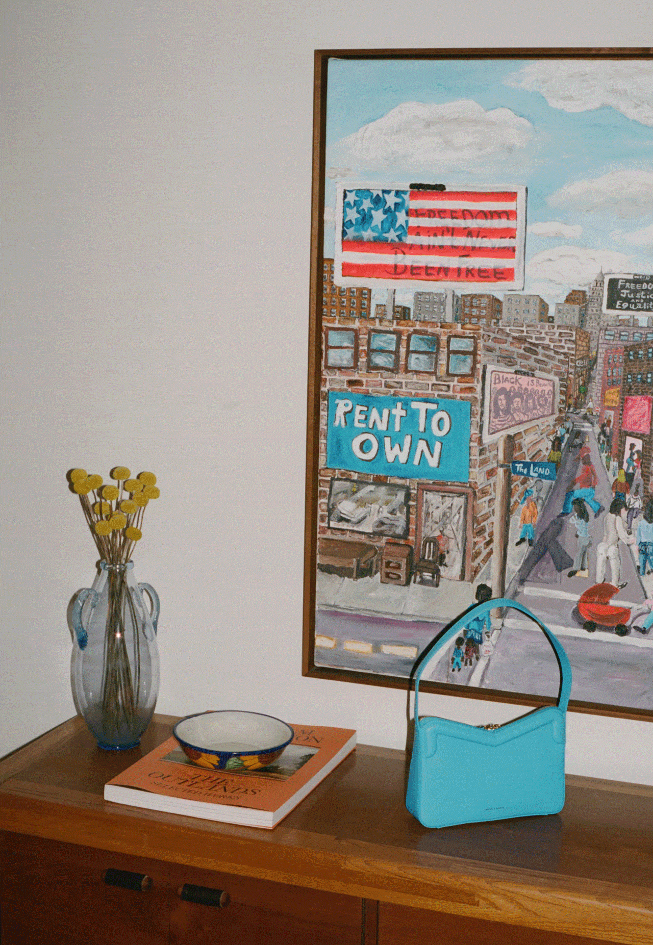 Vignettes from Ava Safdie's apartment including books, her pet cat, a basketball poster and the M Frame Baguette in Piscina.