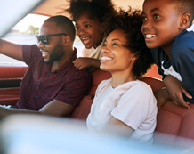 photo of a family driving in their car