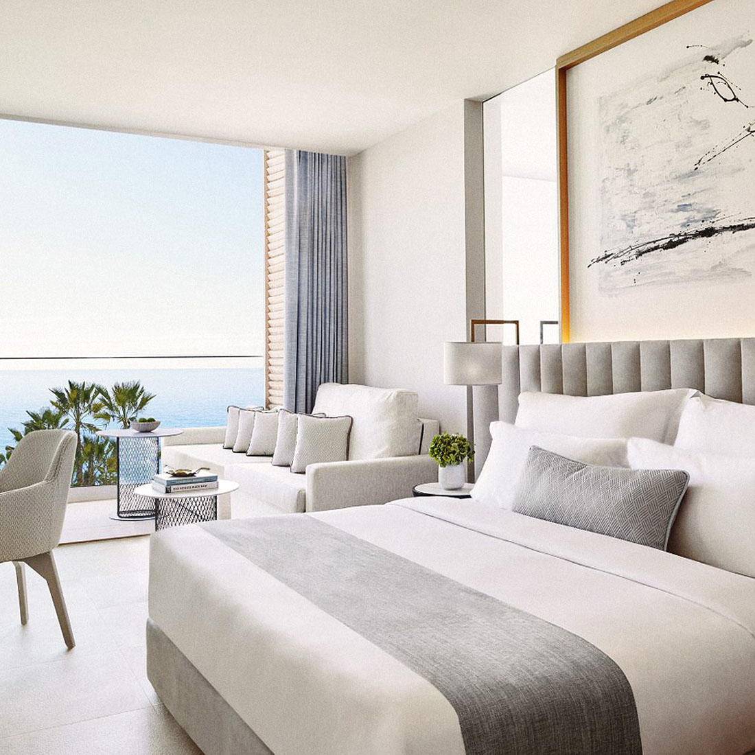 Image description: A light and airy hotel room with an ocean view.