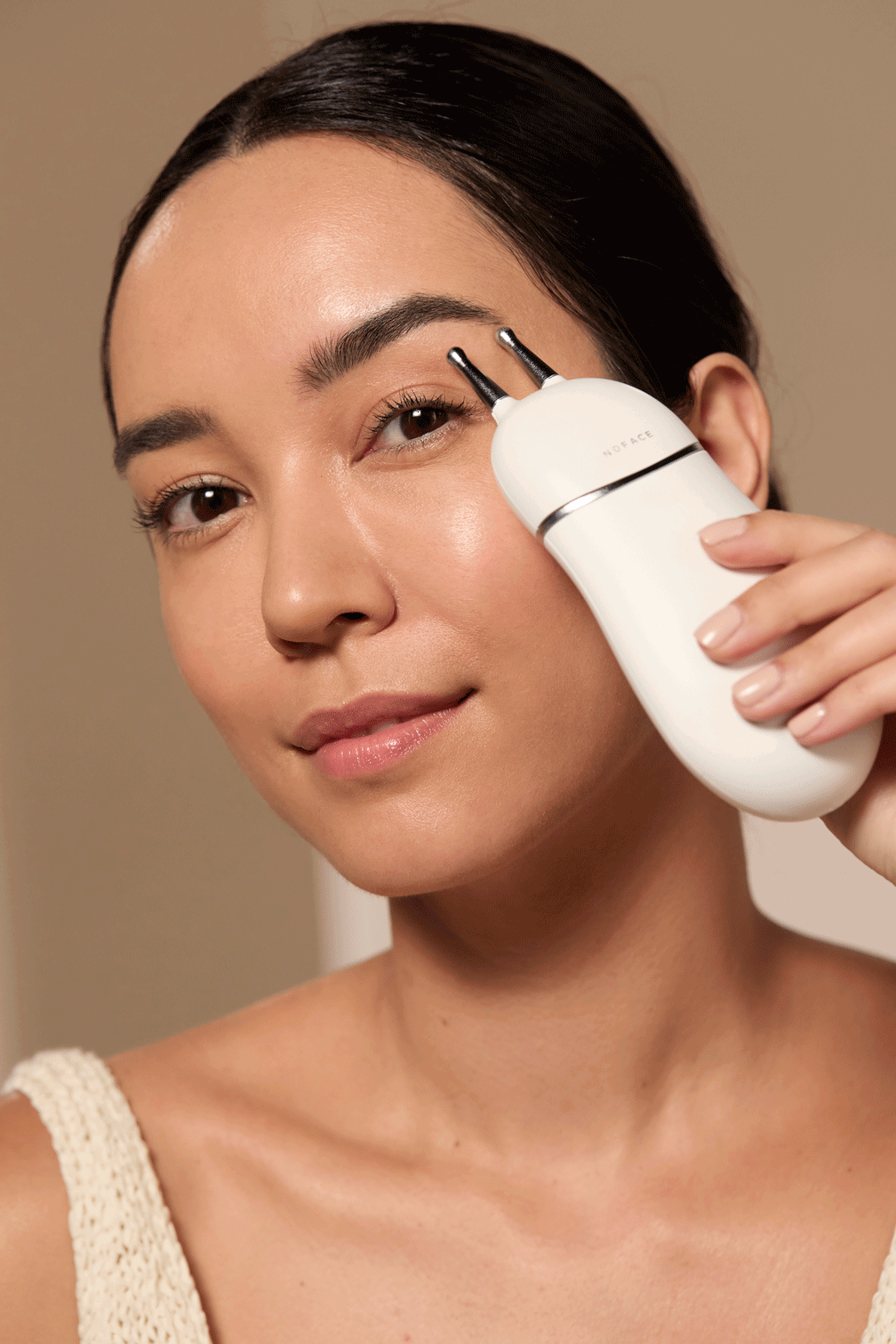 Model using the TRINITY+ Device with the Effective Lip and Eye Attachment to her brow to achieve a lifted appearance.