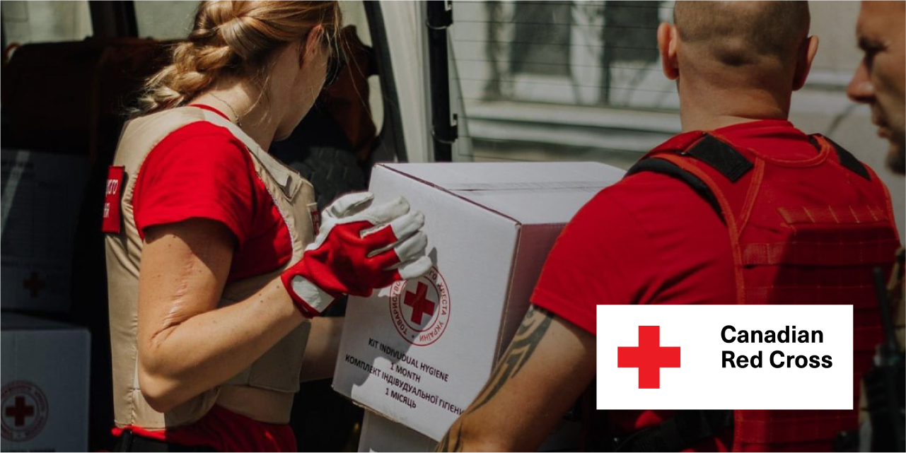 Photo of Canadian Red Cross representatives moving aid boxes.
