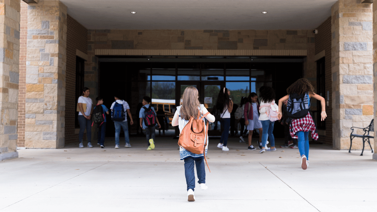Girl running into school