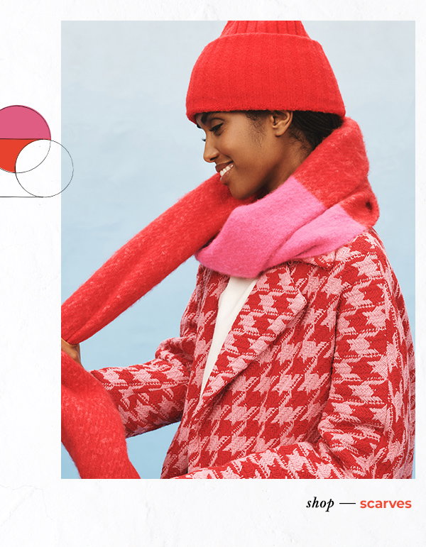 Woman in red houndstooth jacket and red and pink scarf. Shop scarves.