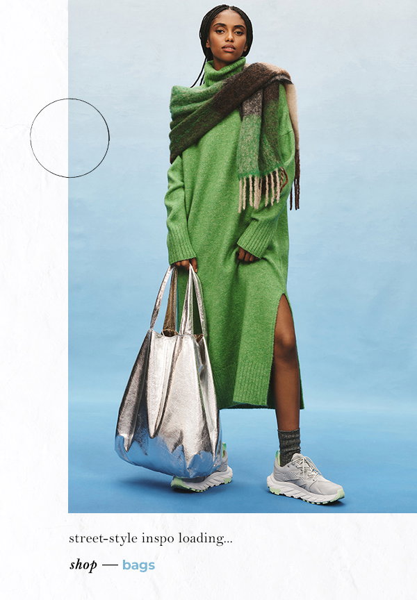 Woman in green knit dress and holding a silver bucket bag. Street-style inspo loading...shop bags.