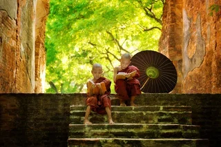 bigstock-Young-Buddhist-monk-reading-ou-46857976