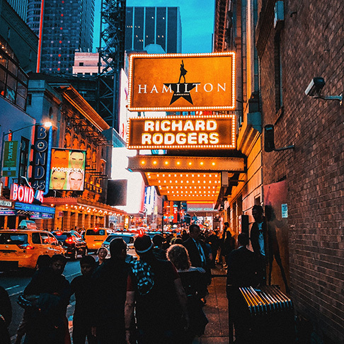 Image Description: Travellers queuing outside the Broadway Theatre to see Hamilton, a famous musical