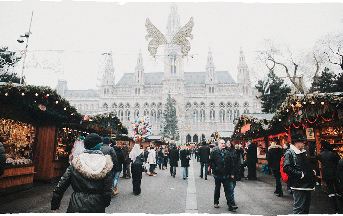 Image Description: A crowd of travellers shopping at the Vienna Christmas Market 