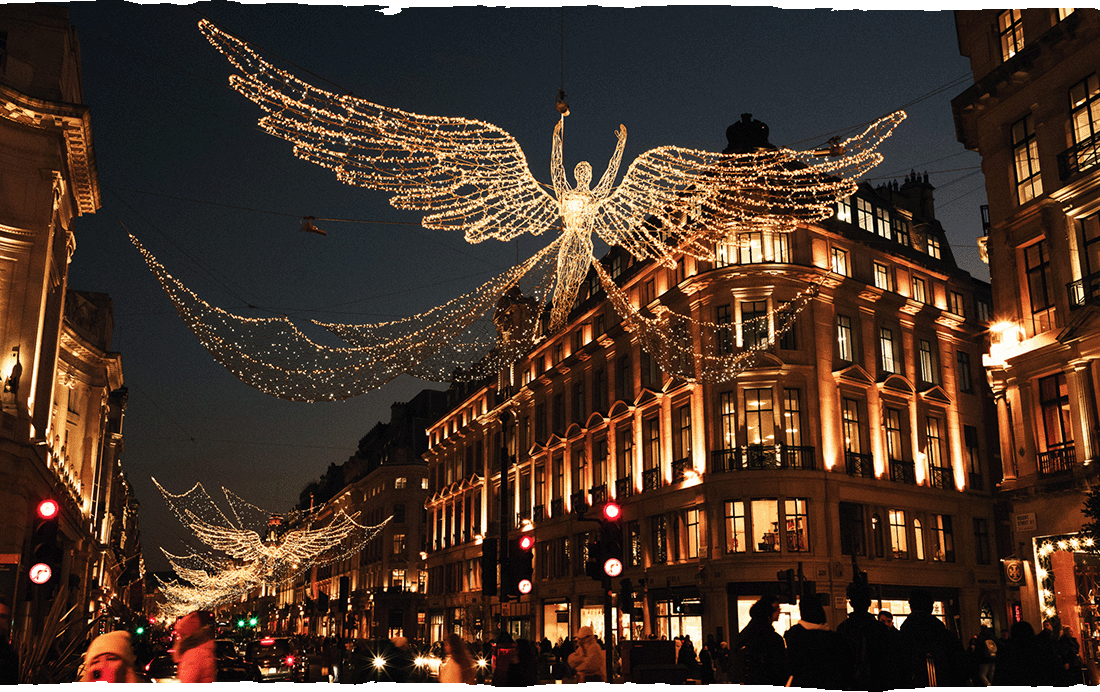 Image Description: Travellers admiring the massive Regent Street festive light-ups, featuring the floating light sculpture of an angel
