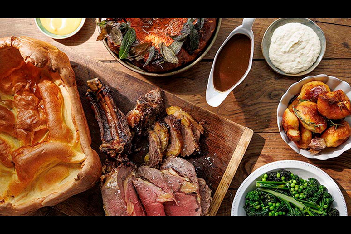 An array of Sunday roast recipes on a wood table 