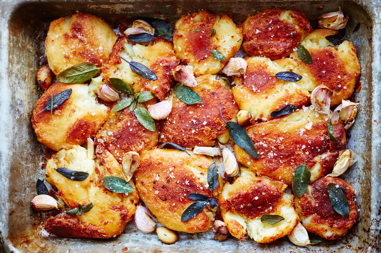 A tray of roast potatoes with garlic and sage