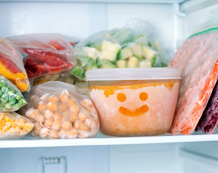Image of various frozen, bagged food in a freezer.