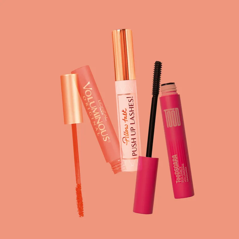 Best Colored Mascara: a collage of L'Oreal Paris, Charlotte Tilbury, and TooD mascaras on a peach background