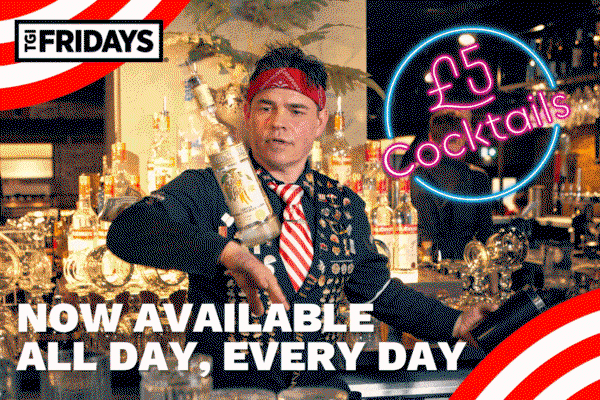 Male bartender flaring and creating cocktails behind the bar at TGI Fridays