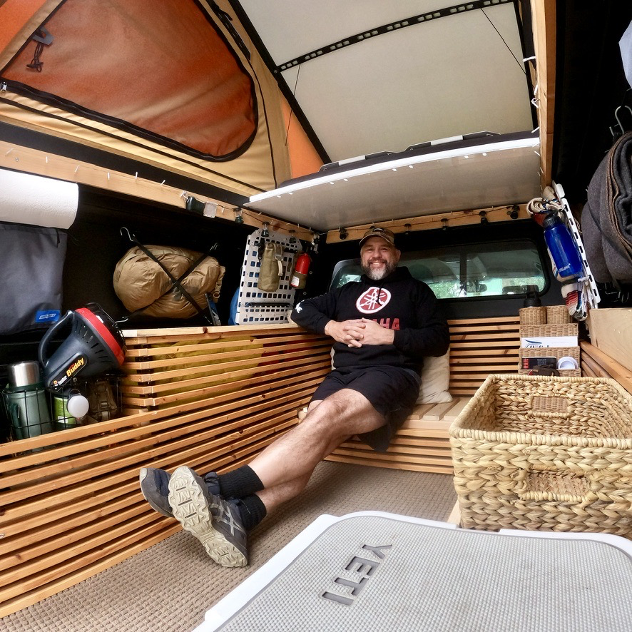 Brett Gaba hanging out in his Dirtbag Chalet.