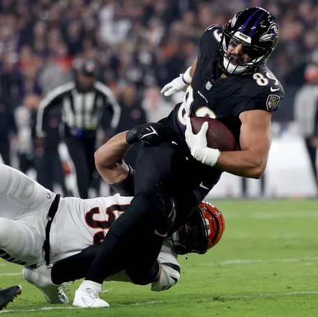 Mark Andrews #89 of the Baltimore Ravens is tackled by Logan Wilson #55 of the Cincinnati Bengals during the first quarter of the game at M&T Bank Stadium on November 16, 2023 in Baltimore, Maryland.