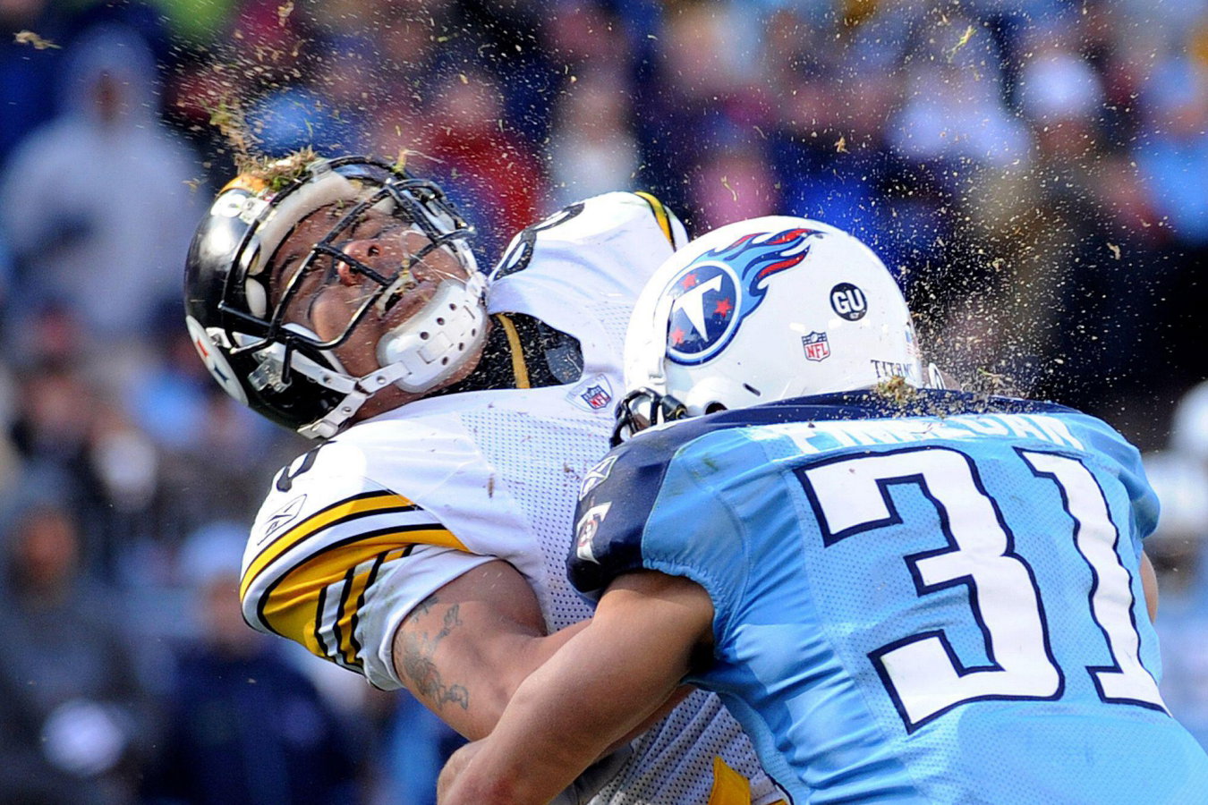 Two American football players crash into each other