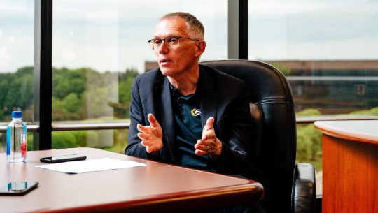 Stellantis CEO Carlos Tavares speaks from behind a desk