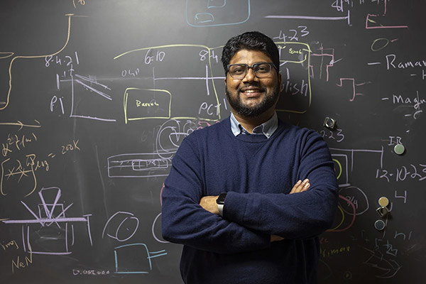 Ranga Dias standing in front of a blackboard.