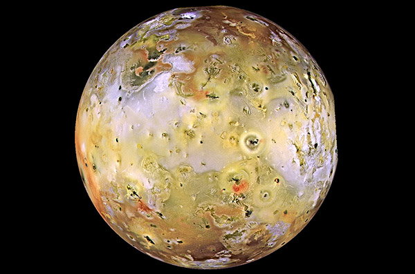 A global view of Io, covered in yellow clouds and red patches.