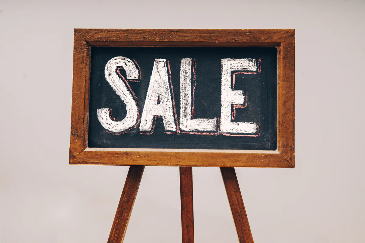 Sale written in white chalk on blackboard with wooden frame