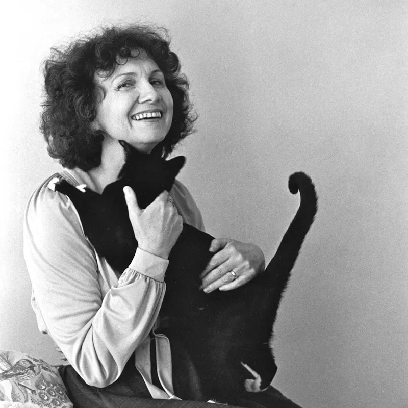 A black-and-white photograph of Alice Munro holding a cat.