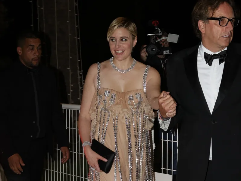Image may contain: Greta Gerwig, Accessories, Formal Wear, Tie, Fashion, Glasses, Jewelry, Necklace, Adult, and Person