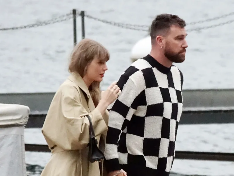 Image may contain: Travis Kelce, Clothing, Coat, Person, Face, Head, Photography, Portrait, Adult, Blazer, Jacket, and Water