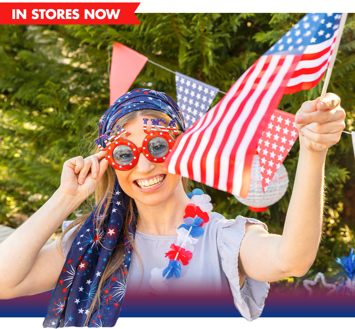 Woman wearing patriotic accessories and holding an American flag