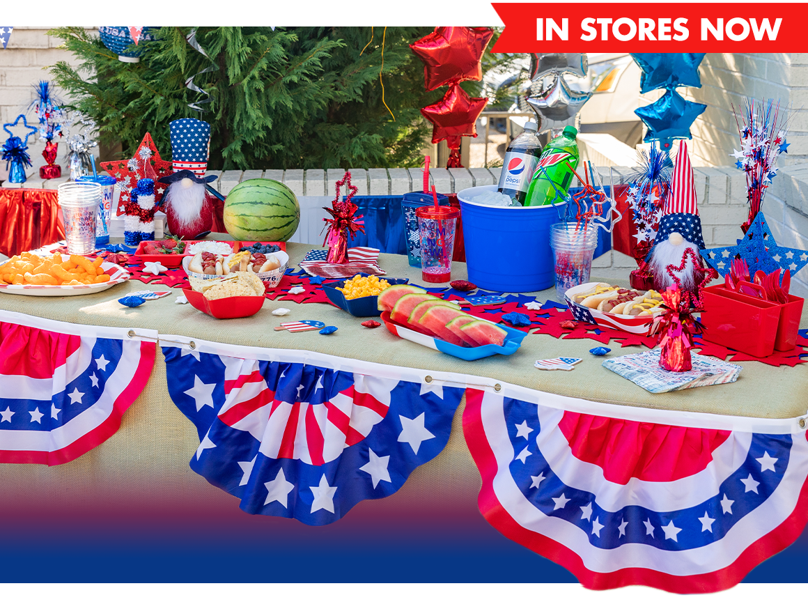 Assortment of food, patriotic decorations, drinks, and more on a table
