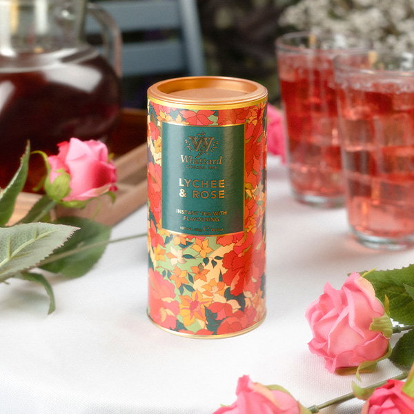Lychee and Rose Instant Tea on a Picnic Table with tall glasses of tea. Roses lie on the table