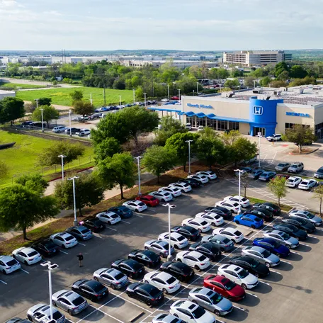 In an aerial view, cars sit on the lot at the Howdy Honda dealership on March 18, 2024 in Austin, Texas