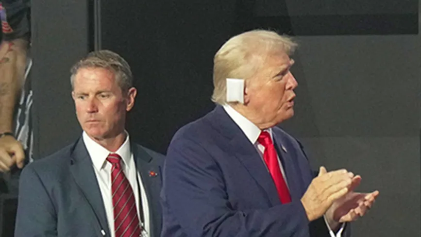 Former President Donald Trump claps as he enters the arena during the first day of the Republican National Convention. The RNC kicked off the first day of the convention with the roll call vote of the states.