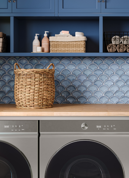 Laundry room close-up of blue fan-shaped mosaic backsplash, washer and dryer visible at the bottom.