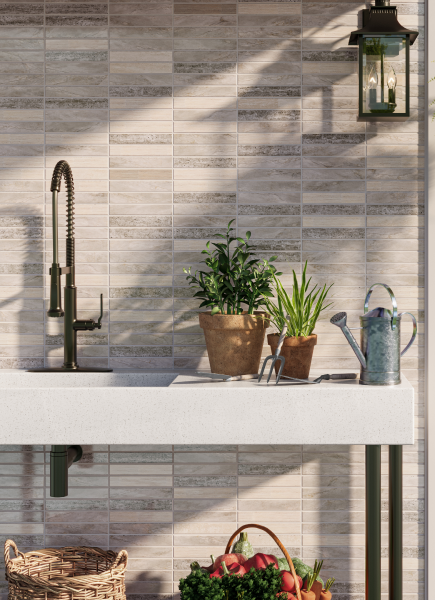 Outdoor garden area close-up of white-gray marble mosaic backsplash tile.