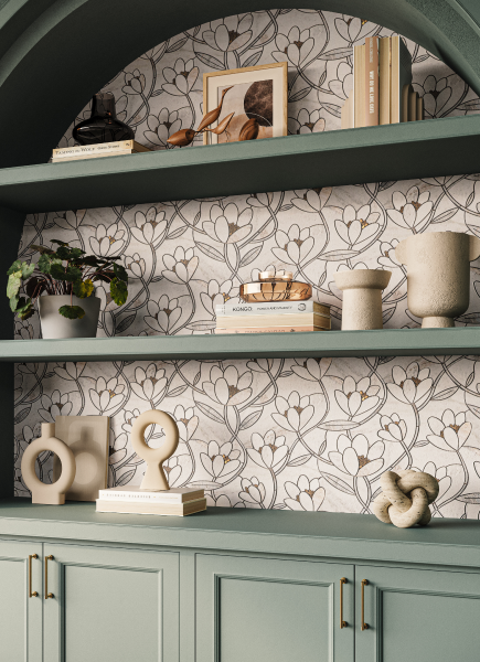 Close-up of tonal green built-in bookcase with flower pattern mosaic backsplash.