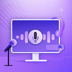 A microphone and headphones next to a computer screen.