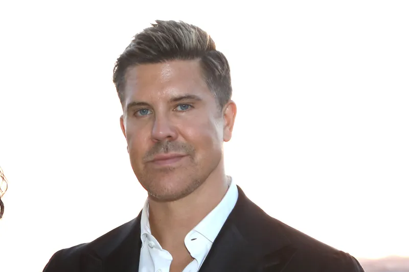 Fredrik Eklund smiling standing on balcony