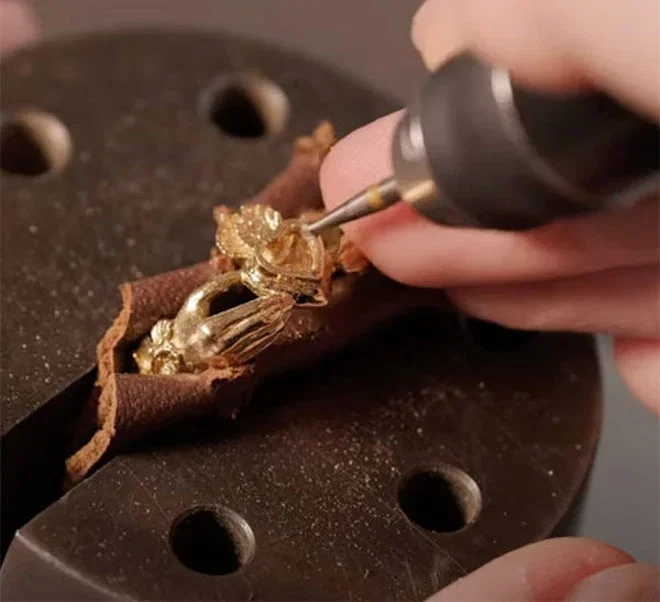 Putting finishing details on the gold ring