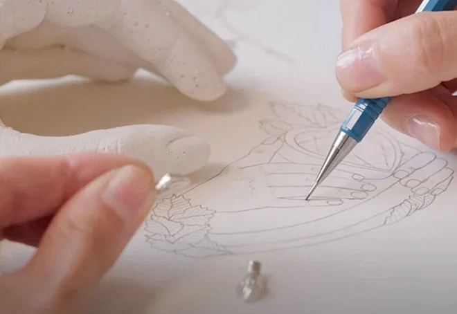 Sketching out a jewellery design on paper