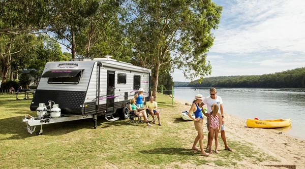 Family camping by the water