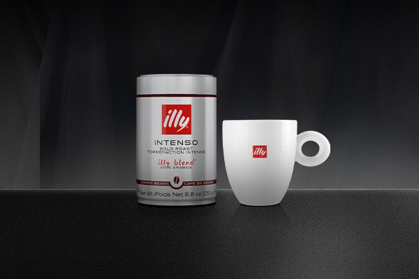 illy whole bean Classico and Intenso cans on a counter