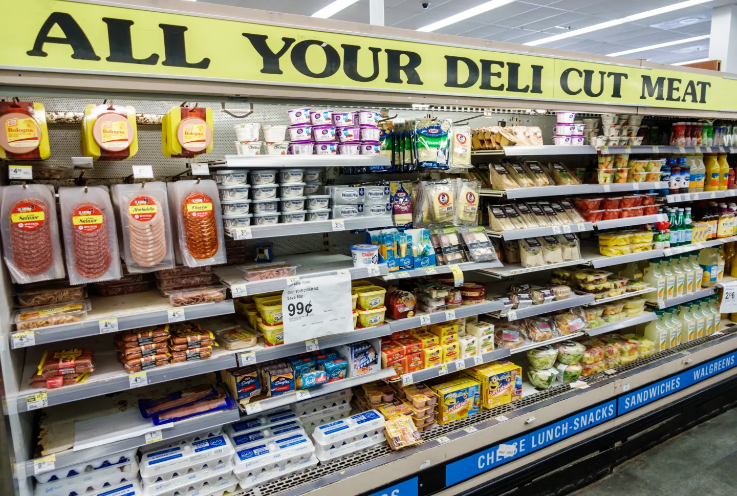 A meat and cheese display at the grocery store.