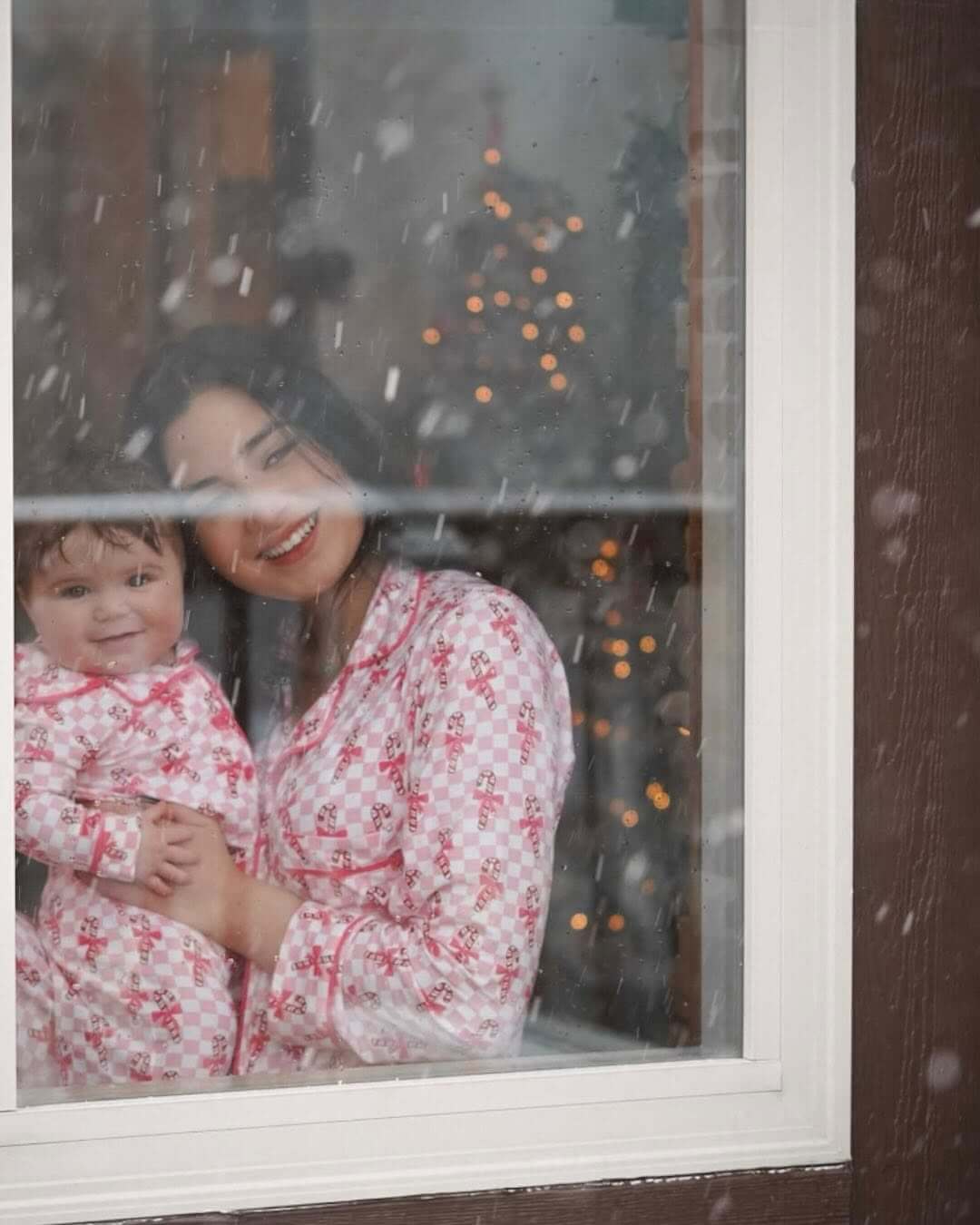 mom and baby looking through window