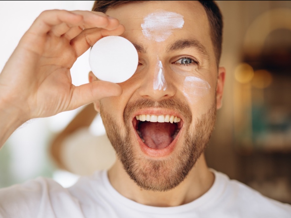 Man applying Hamdah London customised skincare product to his face