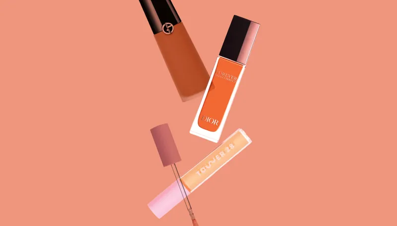 Best Concealer for Mature Skin: a collage of Tower 28, Armani, and Dior concealers on an orange background