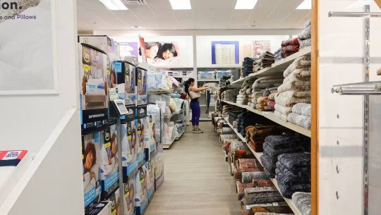 A lone shopper in a long aisle at Kohl’s