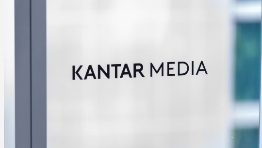 The Kantar Media logo on glass