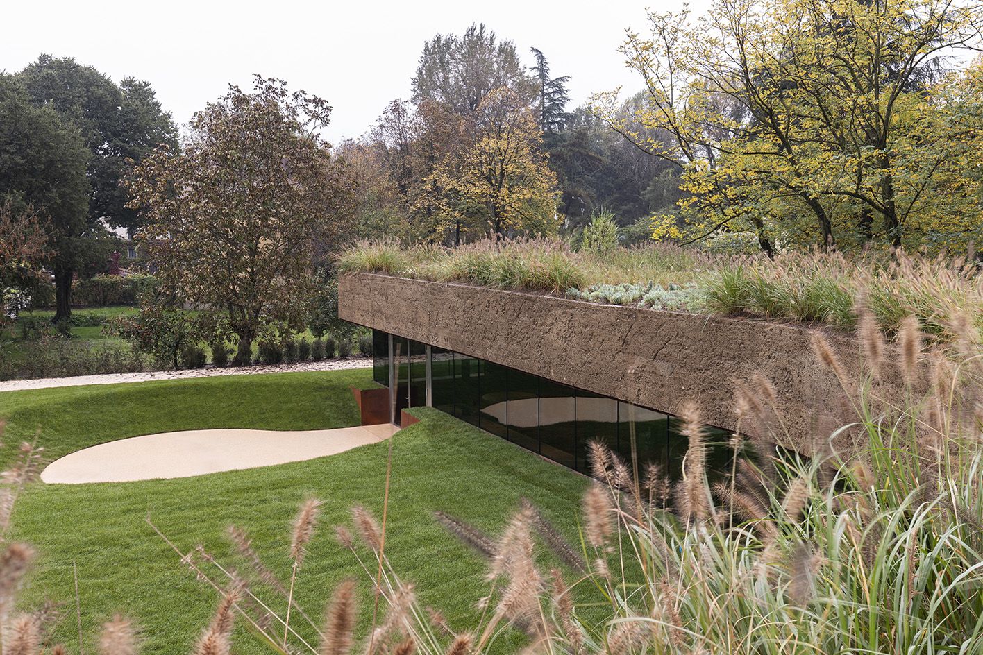green-roofed building set into lawned ground
