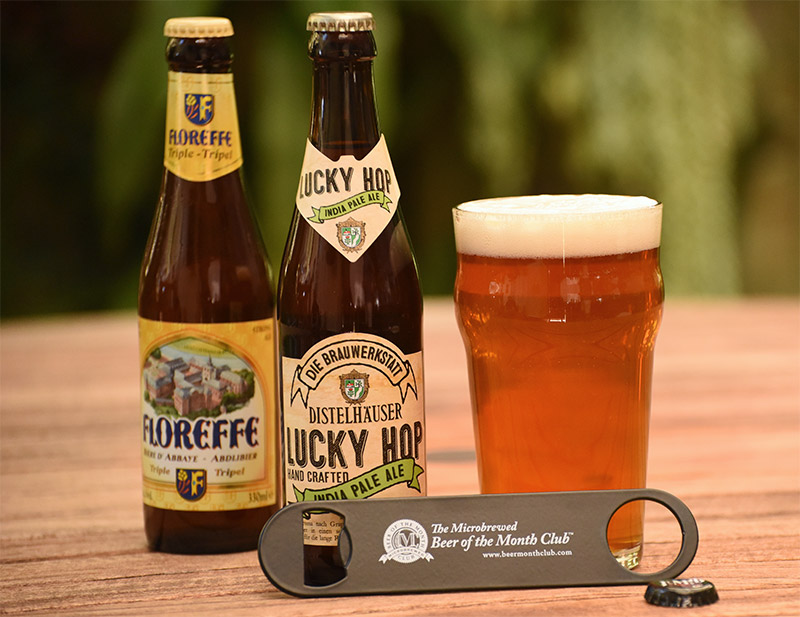 beer glass with two bottles of beer and a bottle opener